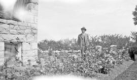 G.F. Watson on sidewalk of house on Ash Road, now Barrie Road