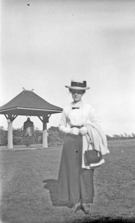 Woman beside Chinese "Boxer" bell in Beacon Hill Park
