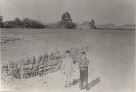 Bill Ruby and friend standing in front of clay pits where original Lee greenhouses were built