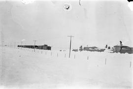 Digging train engine out from snow near Melita, Manitoba