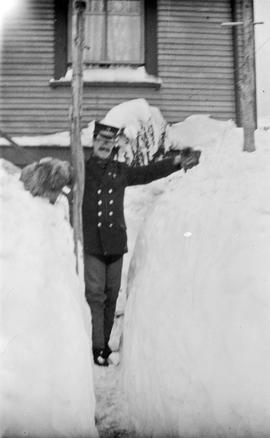 [Charles Croft] standing between piles of snow