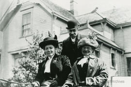 Mrs. Etheridge and Mr. & Mrs. Leeman in front of house