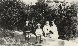 Nellie Ingle Whitehead with her children Ted, Bill and Jack, in a dugout canoe, 1922