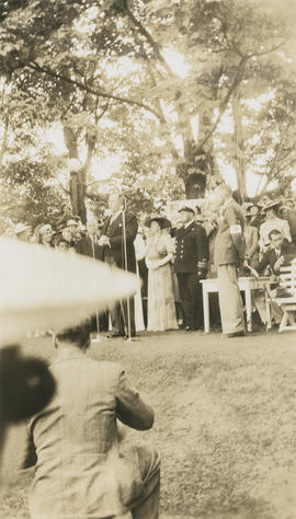 Man speaking to crowd at outdoor event