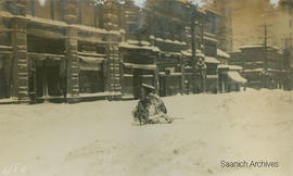 Soldier making his way through snow in downtown Victoria, 1916