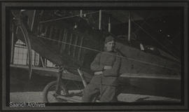 Victor Bartholomew in uniform in front of World War I airplane